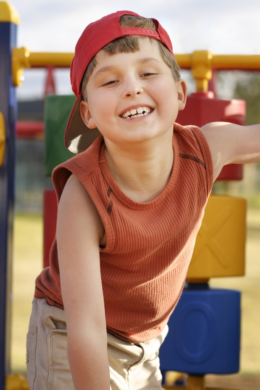 Boy playing on play equipment